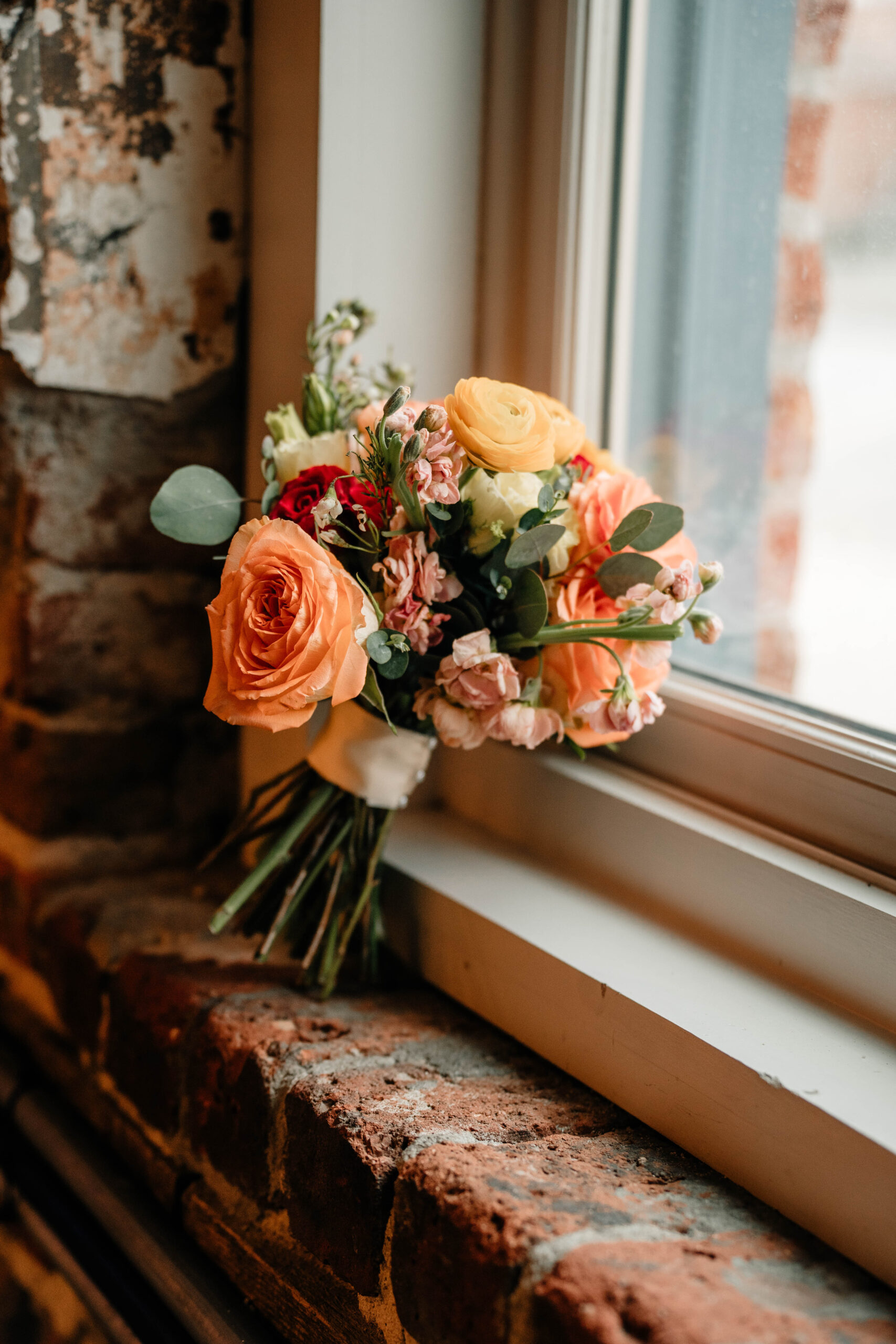 Bouquet in windowsill at wedding venue. 